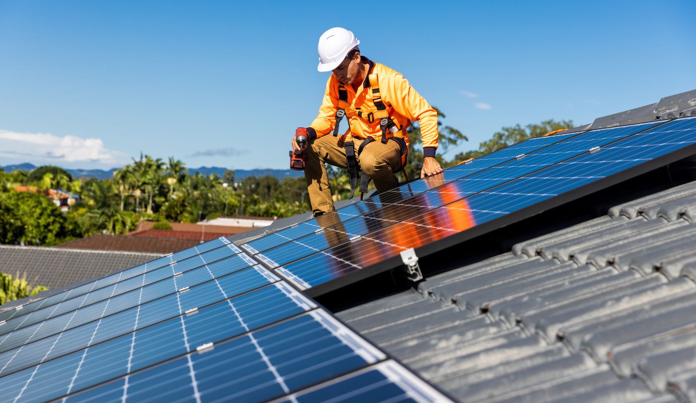 Close-up of solar panels being safely uninstalled with mounting hardware visible