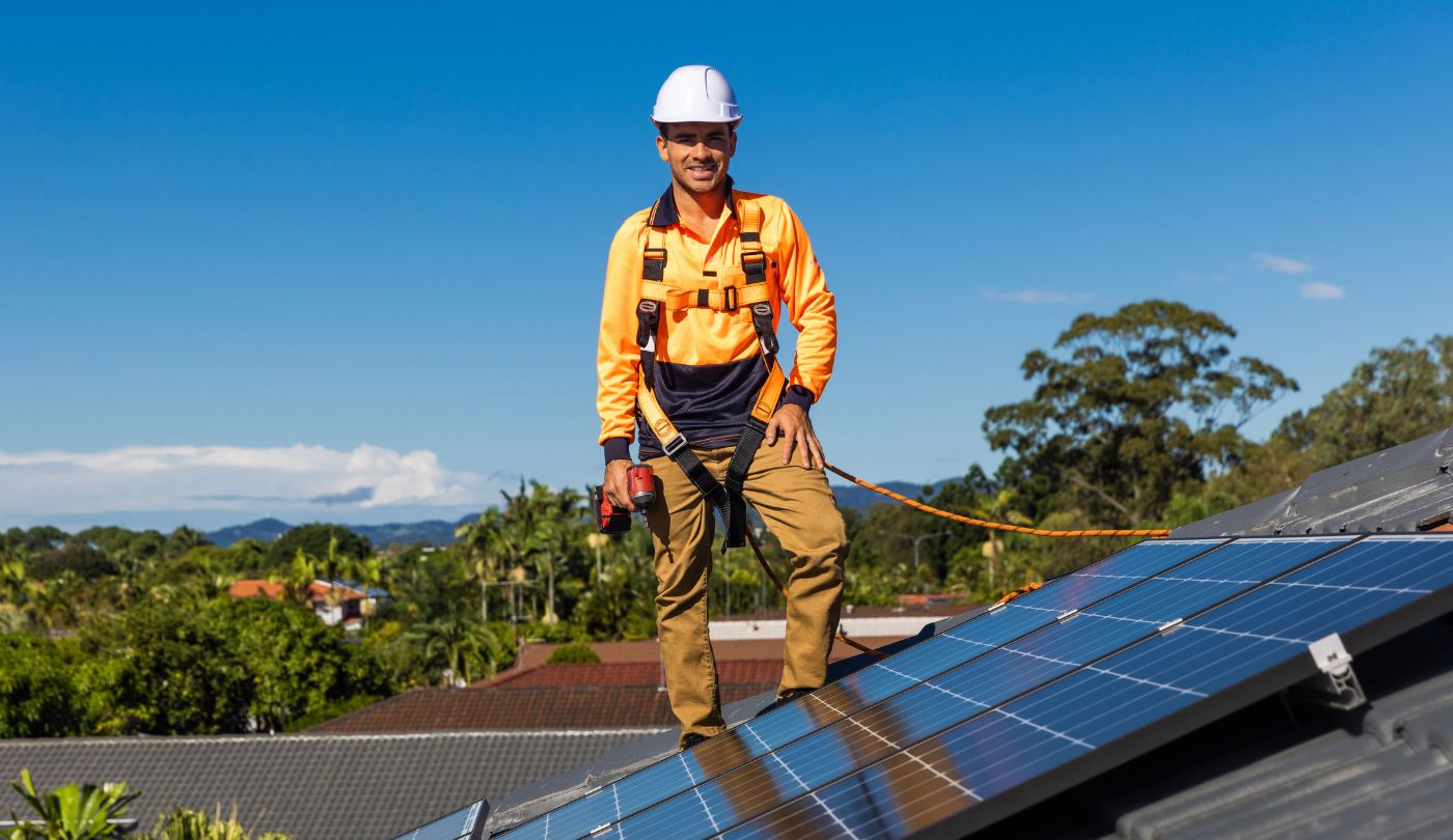 Certified solar technician safely detaching solar panels as part of a roof insurance claim process