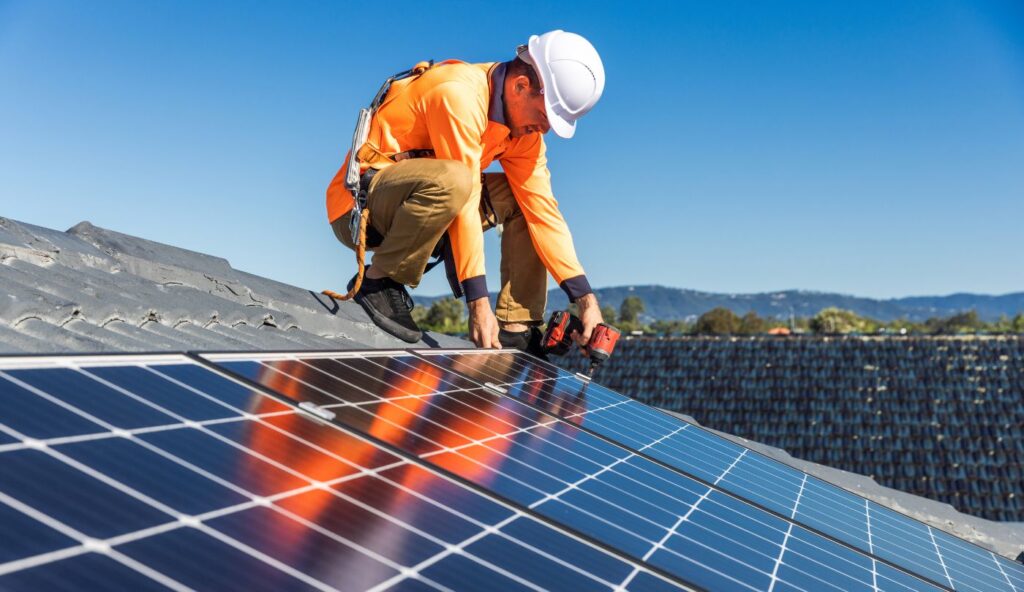 Frustrated homeowner looking at roof damage with solar panels still installed