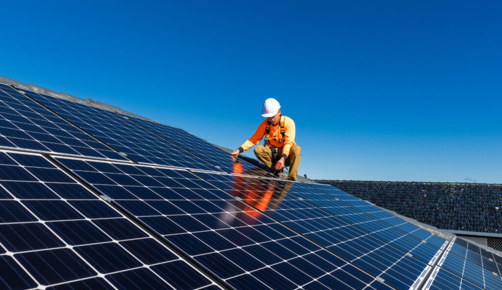 Close-up of solar panels on an aging roof before removal begins