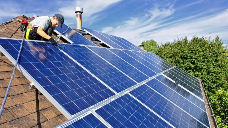 Technician preparing to remove solar panels before a roof replacement in Northern Utah